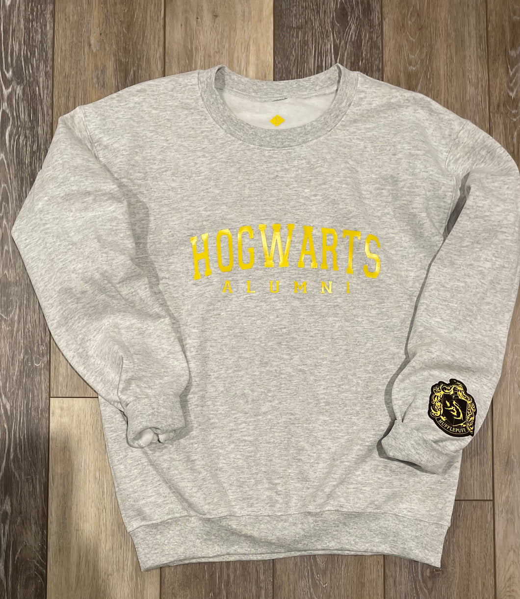 Hogwarts Alumni Sweatshirt with Hufflepuff Crest on Sleeve